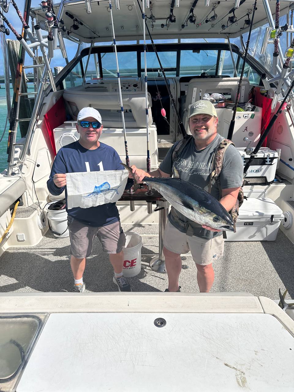 Miss Penny crew with a big blackfin tuna at the dock after a reef edge live bait trip in Islamorada