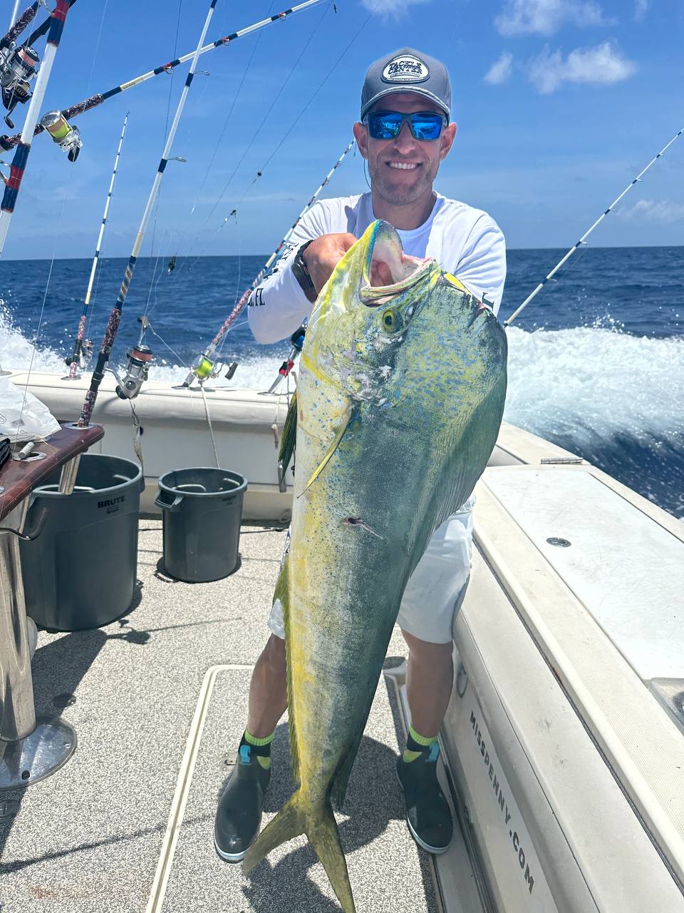 Angler holding a big bull mahi aboard Miss Penny during May offshore fishing